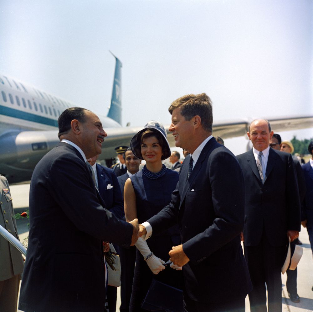 Arrival ceremonies for President Mohammad Ayub Khan of Pakistan. President Ayub Khan shakes hands with President John F. Kennedy; First Lady Jacqueline Kennedy; Secretary of State Dean Rusk (right, behind President Kennedy). Andrews Air Force Base, Maryland.